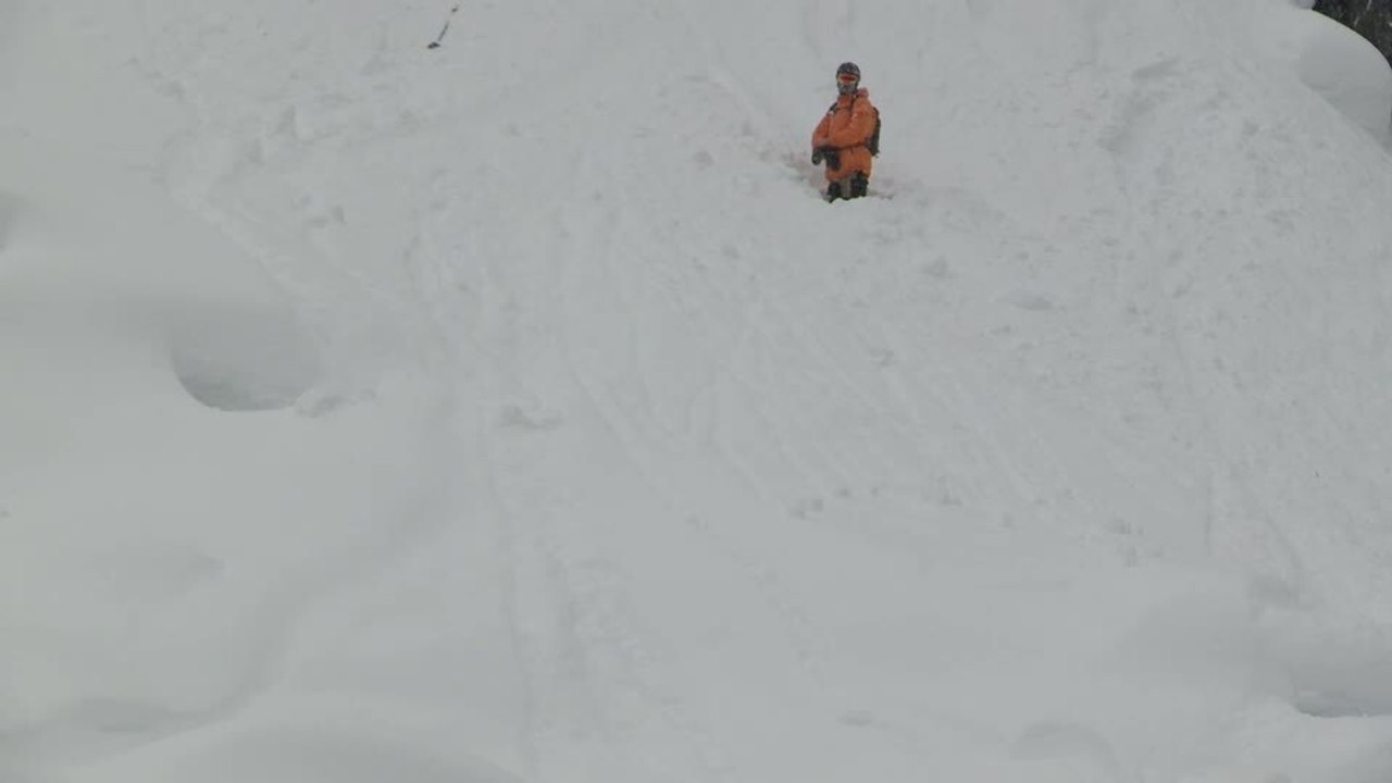 Skier Falls After Snow Breaks During Jump