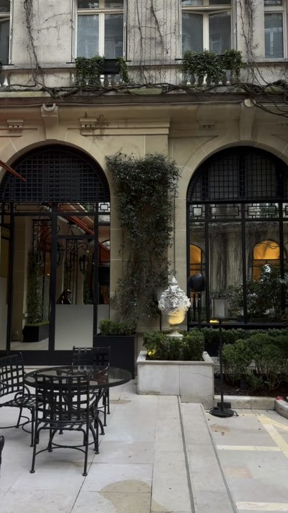Experience the quintessential Parisian elegance in the iconic red-carpeted courtyard of the Hôtel Plaza Athénée, where haute couture meets a lush, ivy-clad sanctuary.