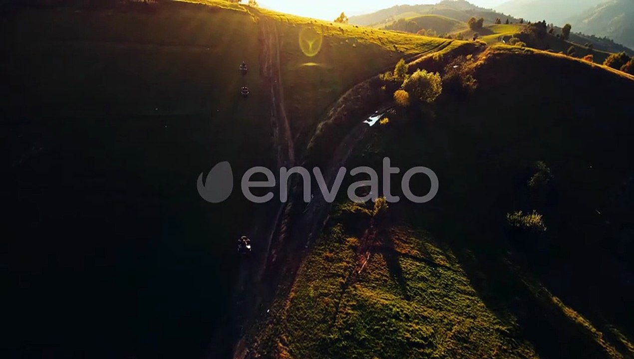 ATVs Ride on Green Hills at Sunrise