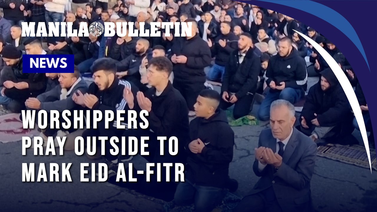Worshippers pray outside Jerusalem’s Old City walls to mark Eid al-Fitr