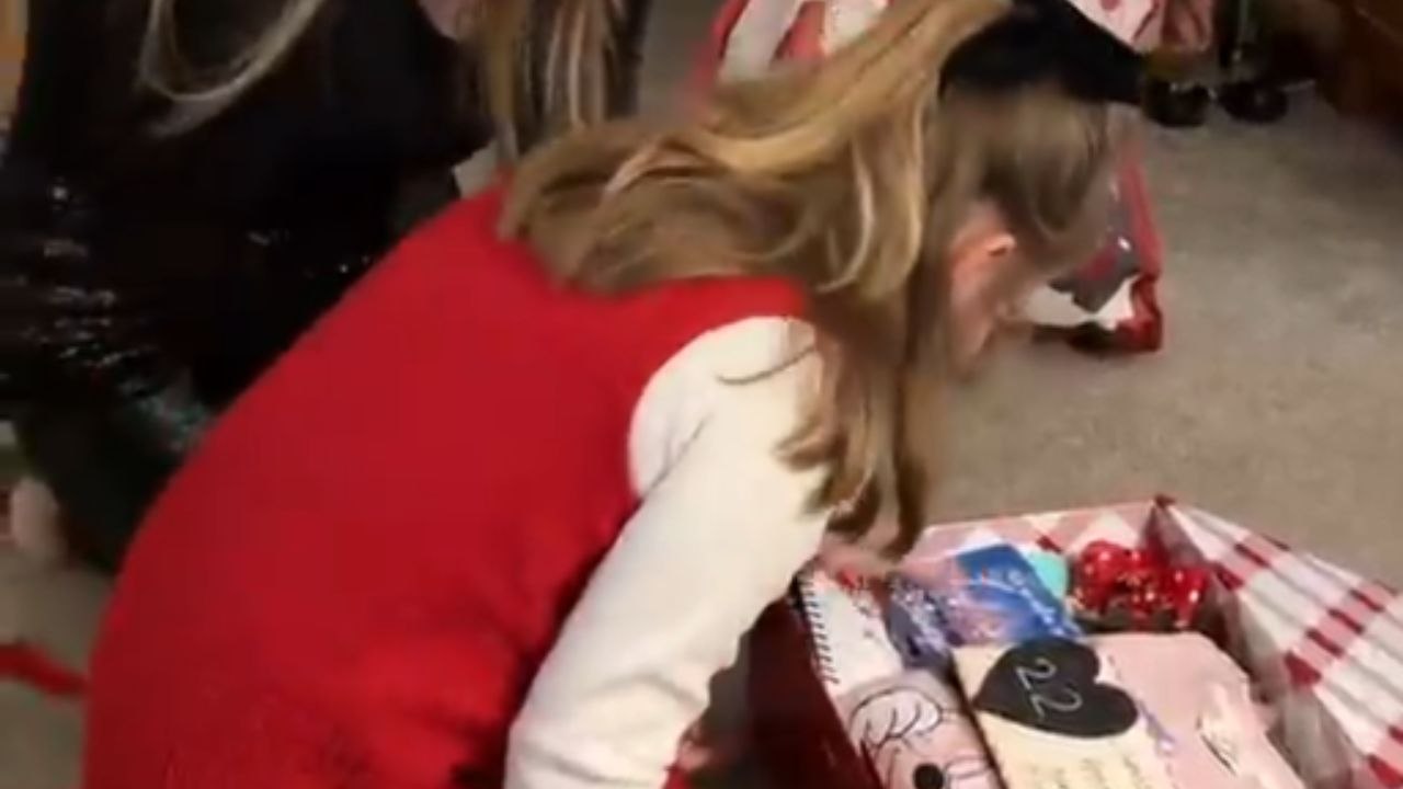Little girl surprised by her mom with Disneyland tickets on Christmas
