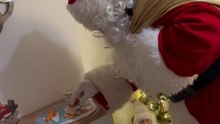 Santa sneaks into a home to deliver Christmas gifts for children