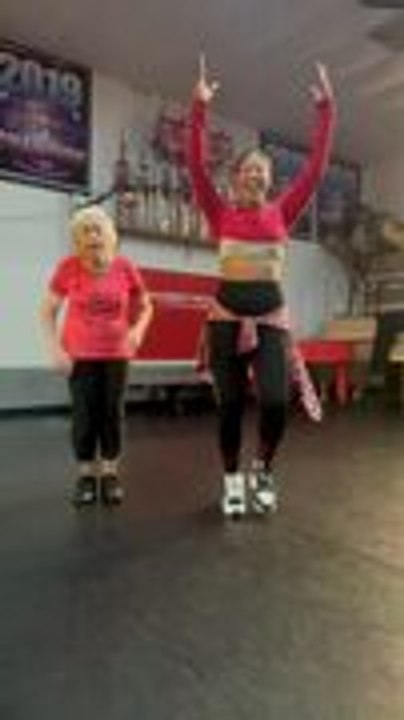 Elderly Woman Joyfully Dances With Another Woman