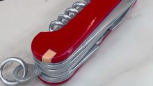 A giant swiss army knife entirely crafted from chocolate yet fully functional