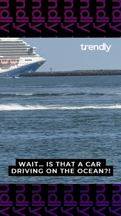 Convertible vehicle surges through ocean waves at Long Beach