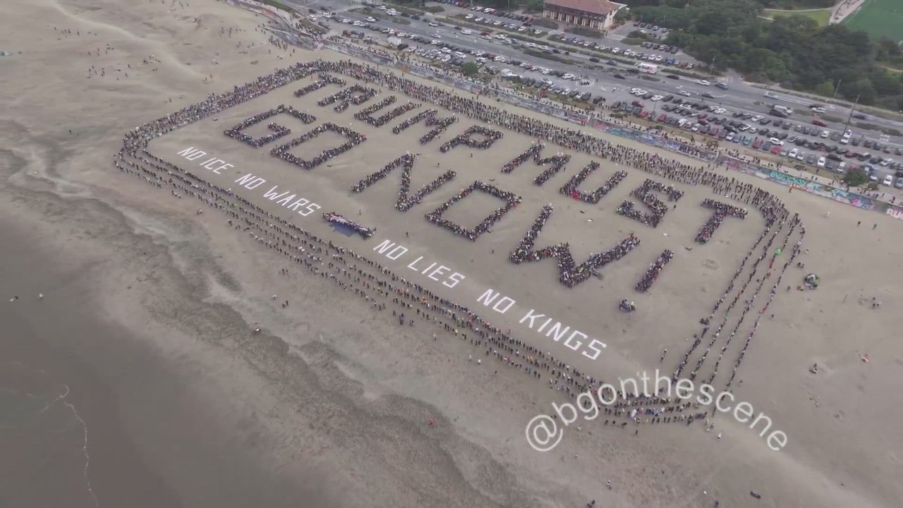 “No Kings” protesters assembled to form a message reading “TRUMP MUST GO NOW!” at Ocean Beach in San Francisco, California today