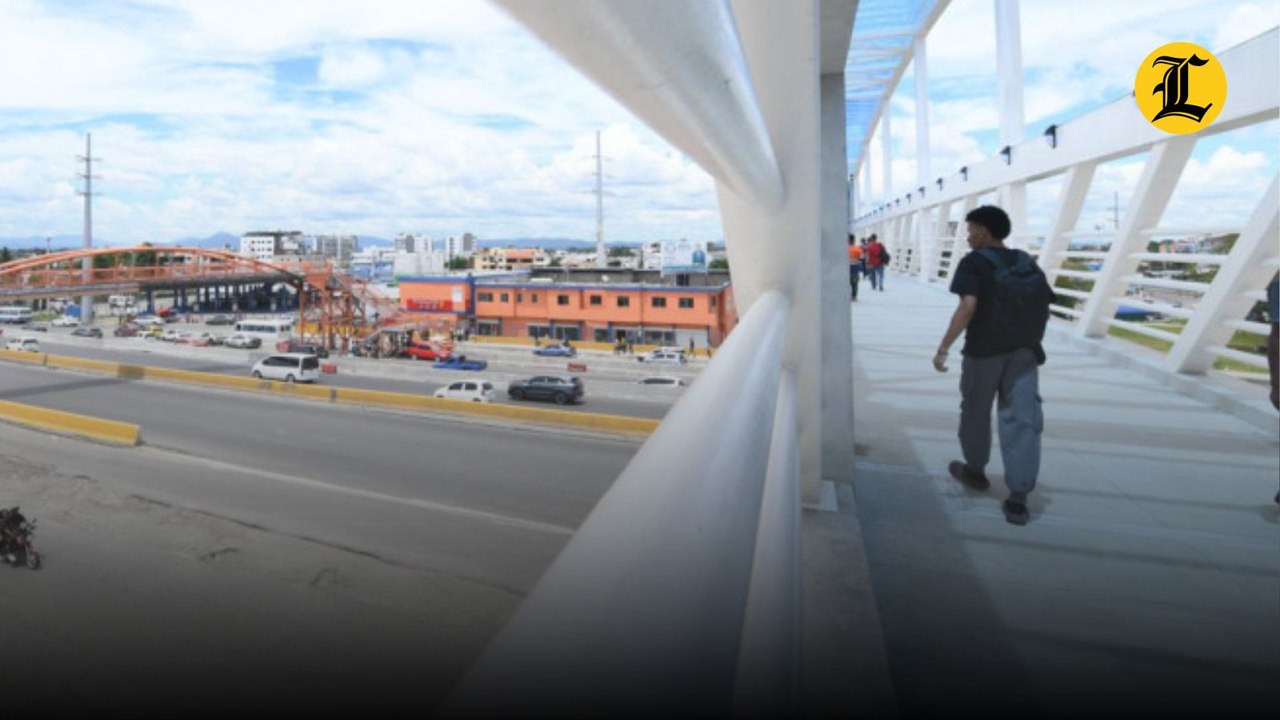 Personas cruzan el nuevo puente del kilómetro 9 de la autopista Duarte