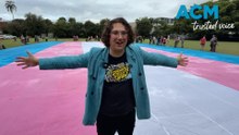 Gigantic trans flag unfurled in bid to reinstate gender affirming healthcare in QLD