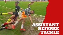 Assistant referee gets tangled up in tackle
