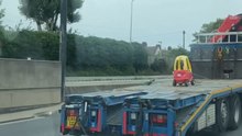 Lonely toy car on a truck bed creates a funny moment for driver