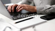 Hands Typing on Laptop in Office Environment