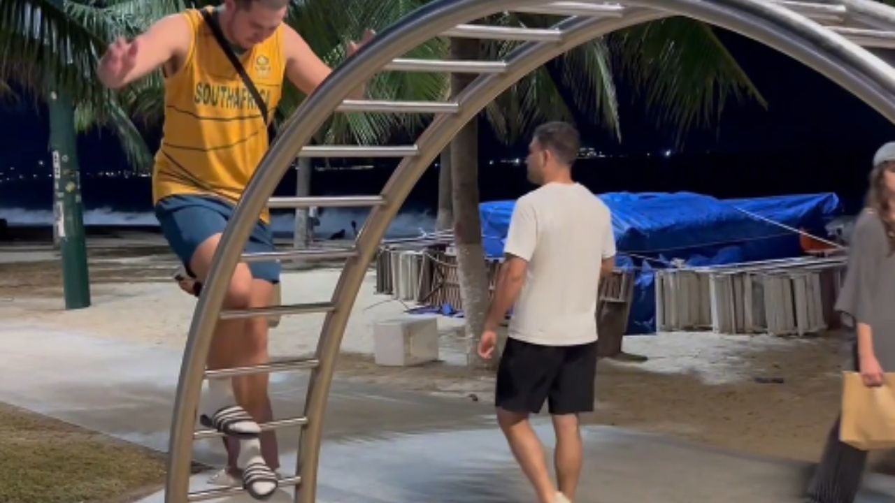 Boy Walks Across A Curved Climbing Arch Without Falling