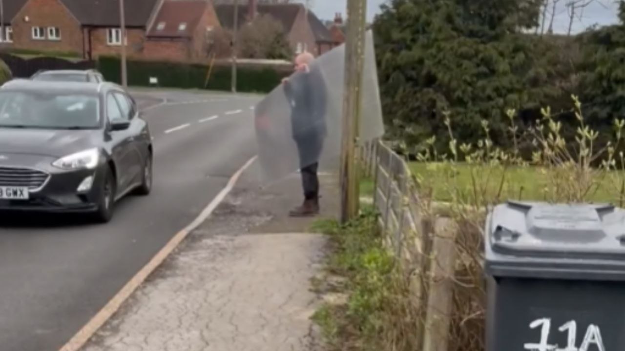Powerful Wind Takes Panel From Man's Hands