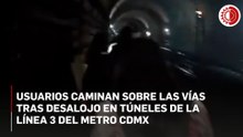 Usuarios caminan sobre las vías tras desalojo en túneles de la Línea 3 del Metro CDMX