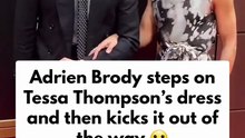 Adrien Brody steps on Tessa Thompson’s dress and then kicks it out of the way on the red carpet