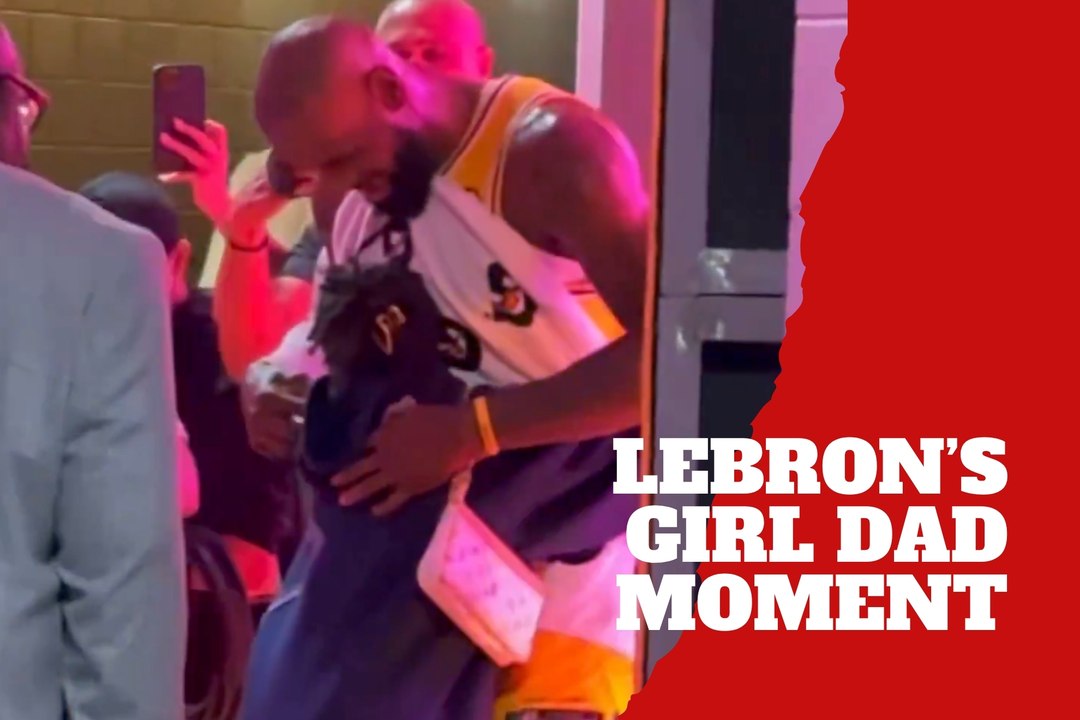 LeBron James covers his chest before hugging Zhuri
