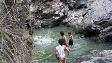 Water in come from stone and people bathing and enjoying