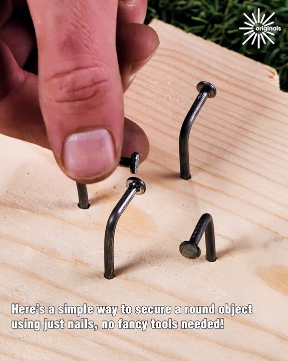 Using just nails to hold a round object in place 🔧
