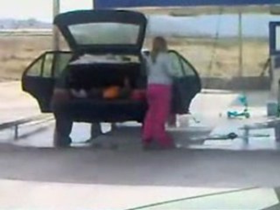 Woman cleans a car!