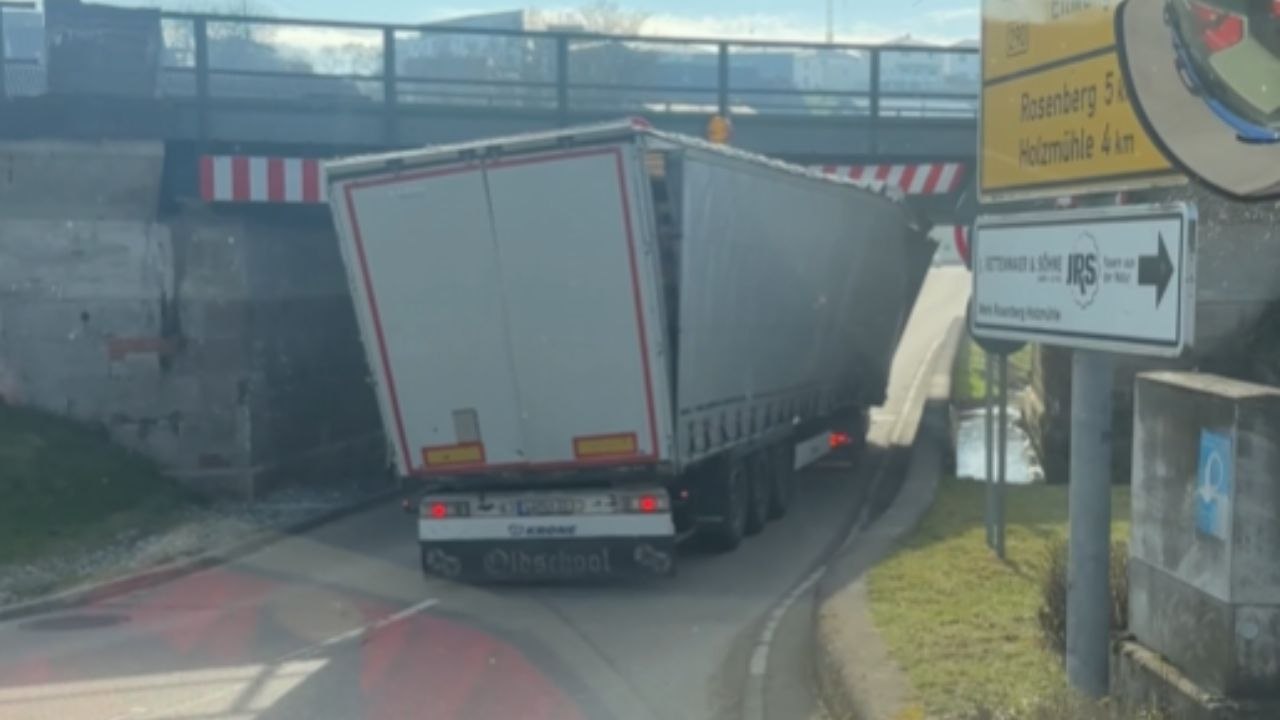 Truck Lodges Under A Bridge