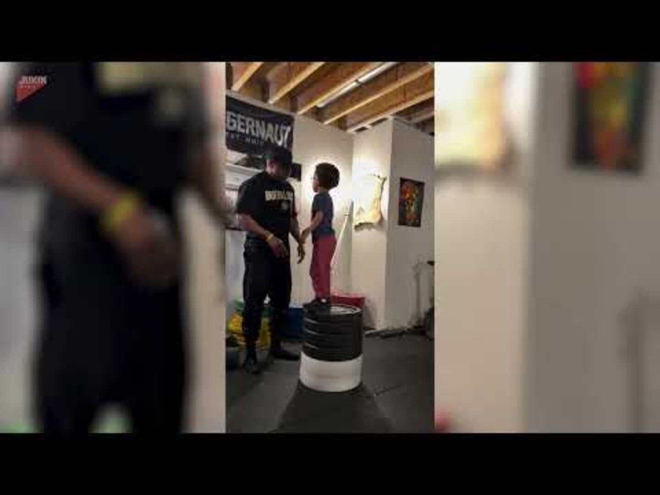 Boy Overcomes Fear by Jumping Onto Tall Stack of Weight Plates