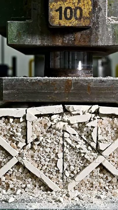 Hydraulic press crushing solid plaster molds......