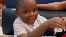 Little Boy Looks At His Birthday Presents And Does Not Hold Back His Excitement