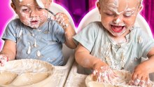 The twin toddlers make a huge mess while trying yogurt with spoons