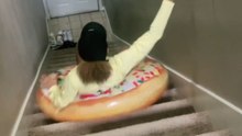 Woman uses a pool float to go down the stairs *Hilarious Misadventure*