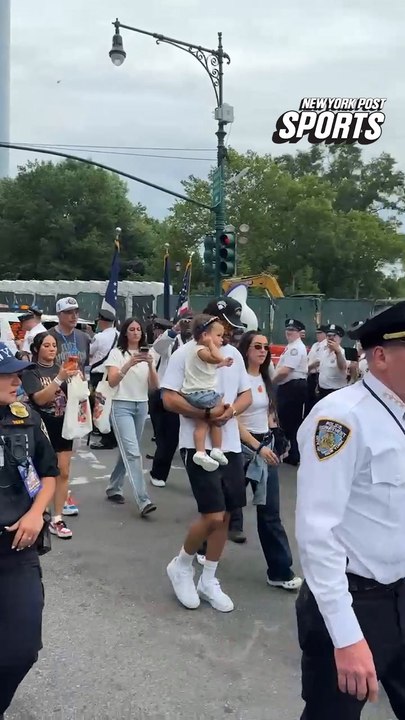 Leon Rose, Jalen Brunson, Jose Alvarado and OG Anunoby walking with their families to the floats before the parade.