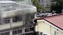 Children wait for rescue on window ledge as fire rages at Tokyo school