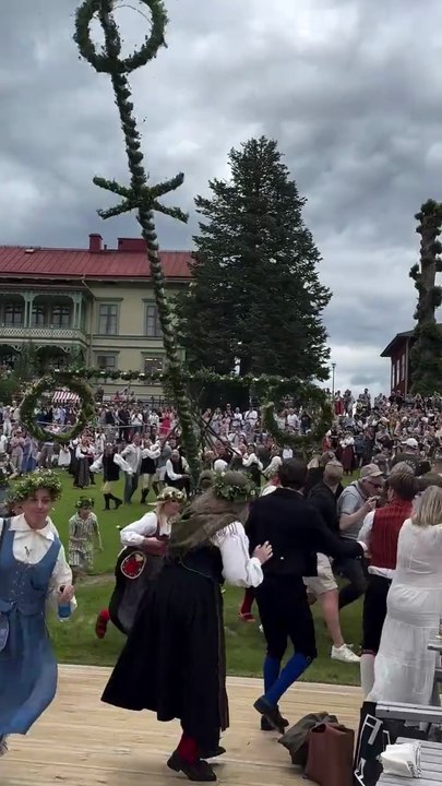 Traditional Swedish Midsummer Celebration: Maypole Dancing and Festivities