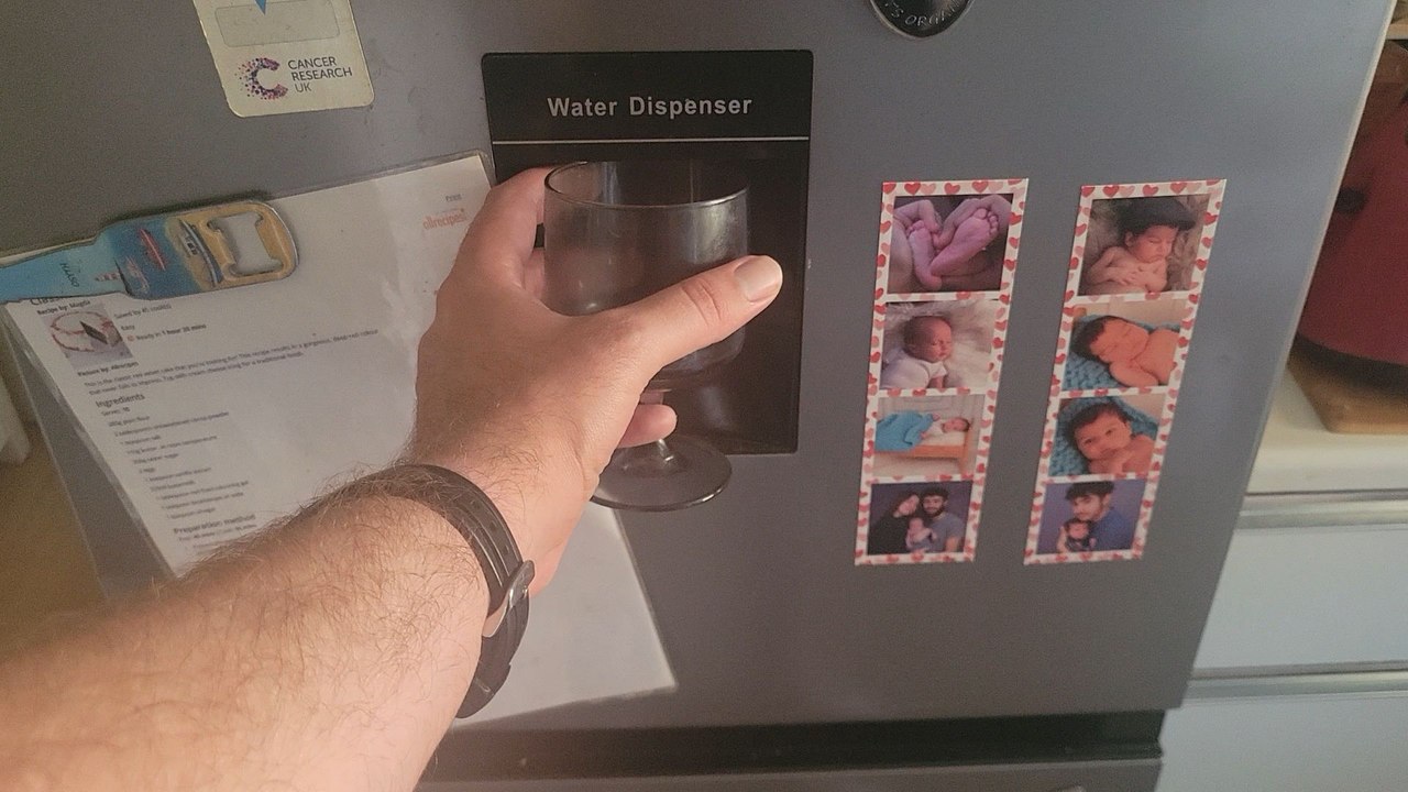 At the kitchen pouring water in my glass