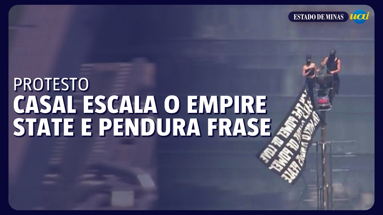 Casal escala Empire State ilegalmente e pendura frase no topo