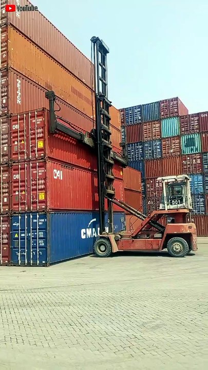 Nissan CWM 330PS  carrying a CMA CGM container at the Dwipa Kharisma Mitra container depot.