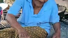 90 Year Old Grandma Cutting Roasted Hot Coconut