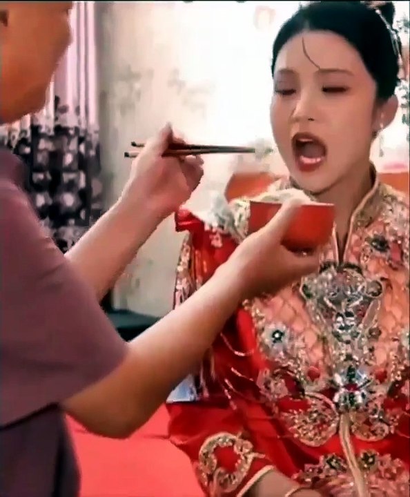 In China, it's a tradition for the father of the bride to feed her one last time before her wedding