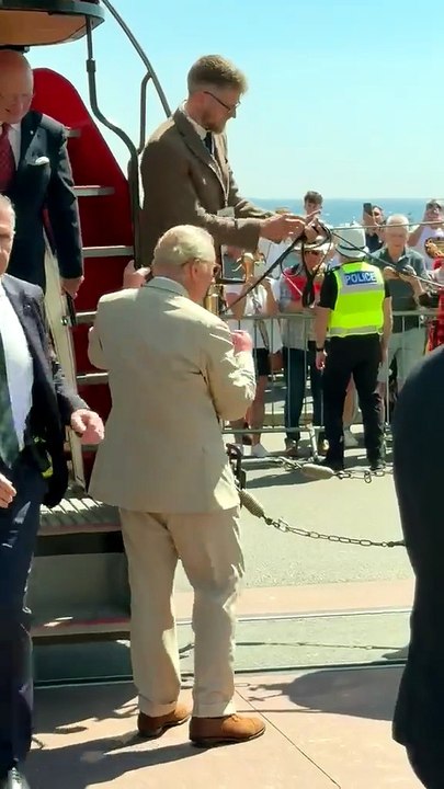 King Charles steps off the horse tram at the end of the journey