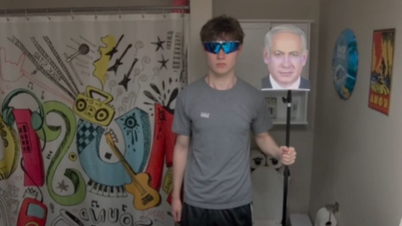 Boy Scares His Grandpa With A Photo On A Stand By The Door