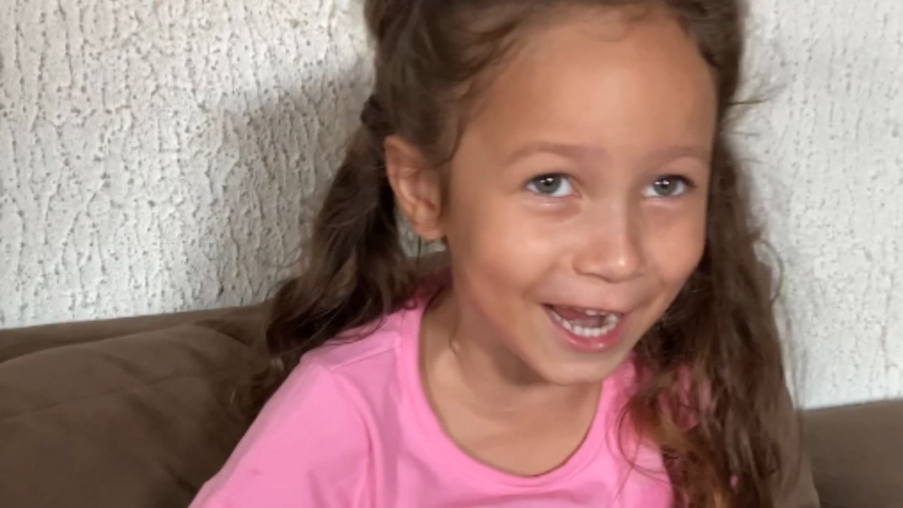 Girl Overwhelmed with Joy after Receiving Puppy for Children's Day