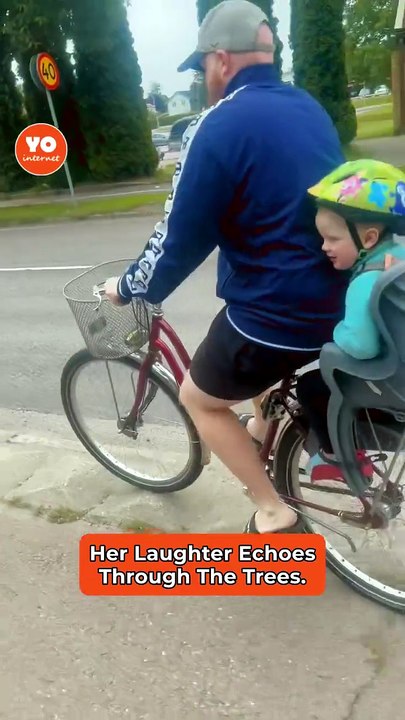 Joyful Child Laughs While Biking Over Bumpy Trail with Dad