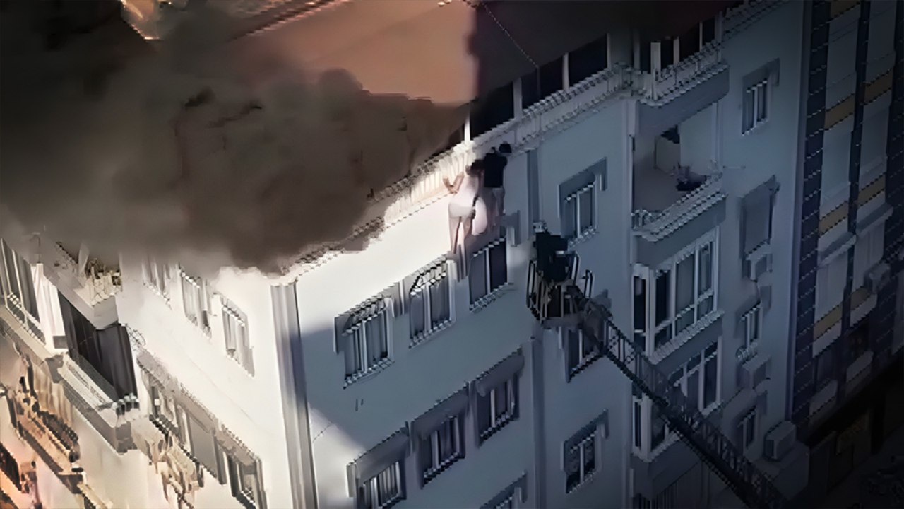 Yangından kaçmak için terastan sarkan gençler son anda kurtarıldı