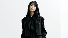 A woman wearing a men's suit