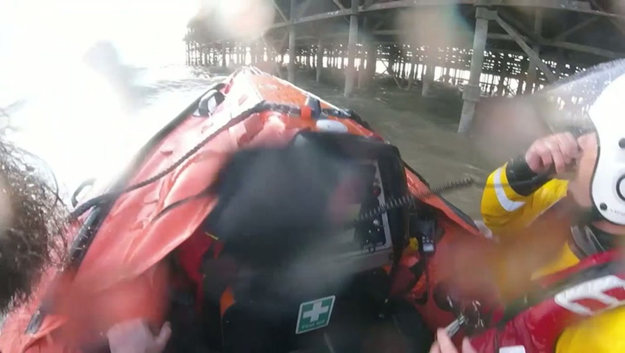 Children dragged under pier by powerful waves saved in dramatic rescue