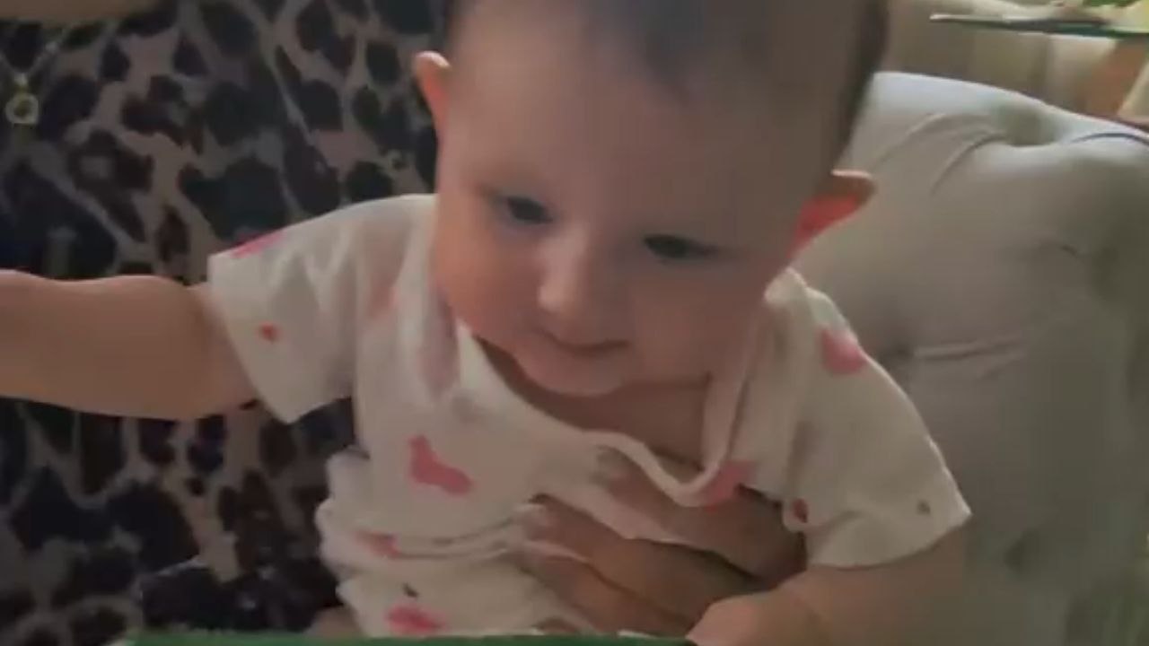 Determined Five-Month-Old Takes on a Piece of Paper