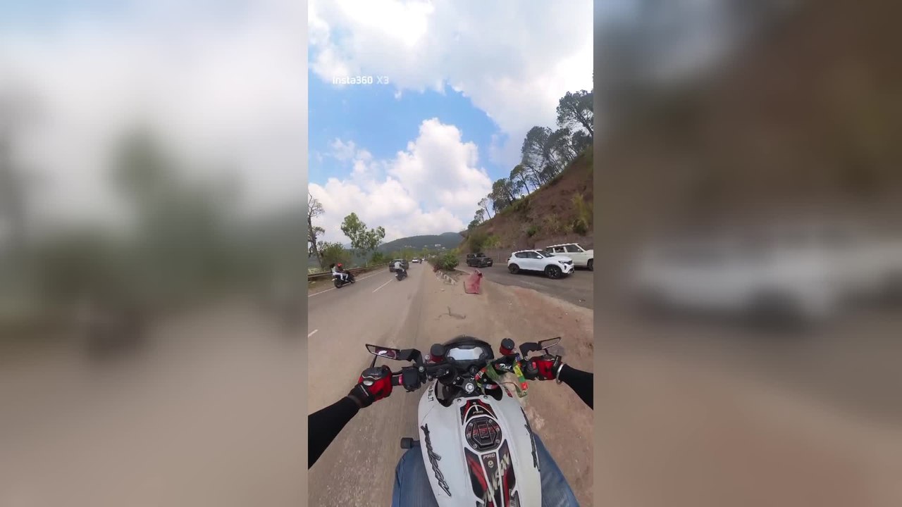 Biker Crashes Into Moving Car After Losing Balance