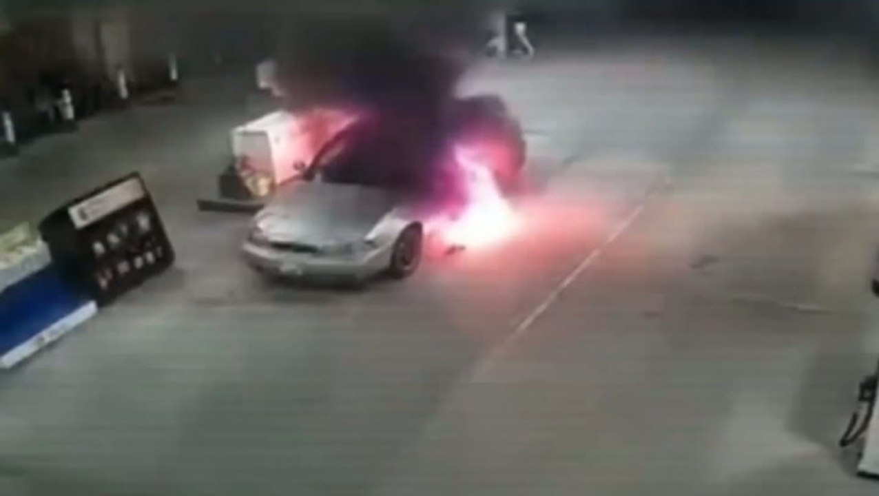 Driver and passenger flee through flames as car erupts into fireball at petrol pump