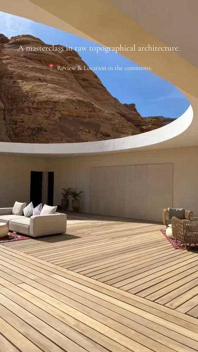 Welcome to Secret Haven. We curate the world's most exceptional stays for demanding travelers. This specific desert sanctuary caught our editorial team's attention because of its monumental curved ceiling cutout flawlessly framing the raw, towering sandst