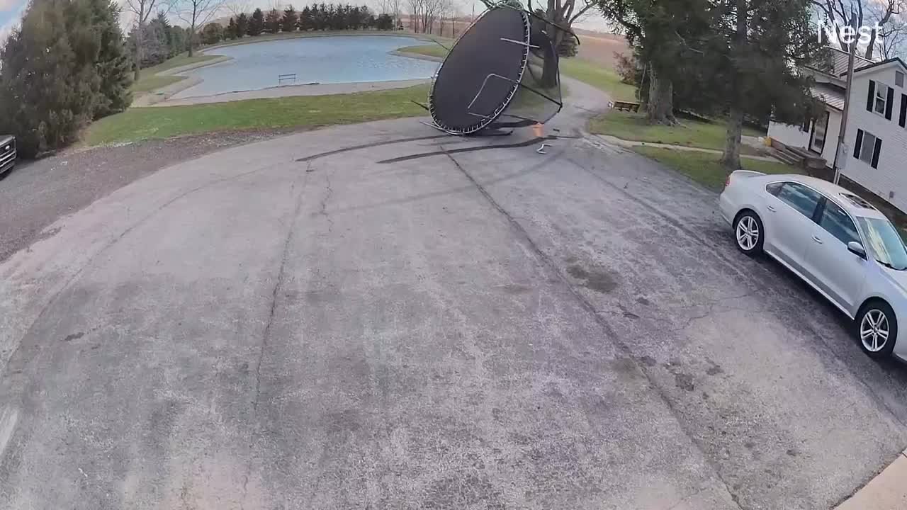 Powerful Gust of Wind Blows Trampoline Into Pond