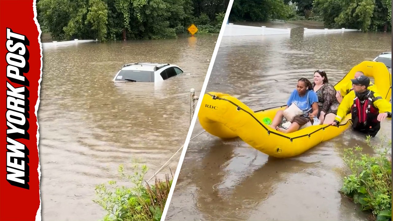 Boats replace cars as firefighters brave waist-deep floodwaters to rescue stranded residents